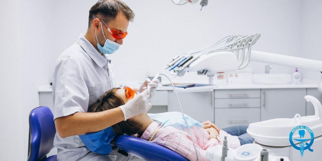 Dental professional treating a patient in a dental chair