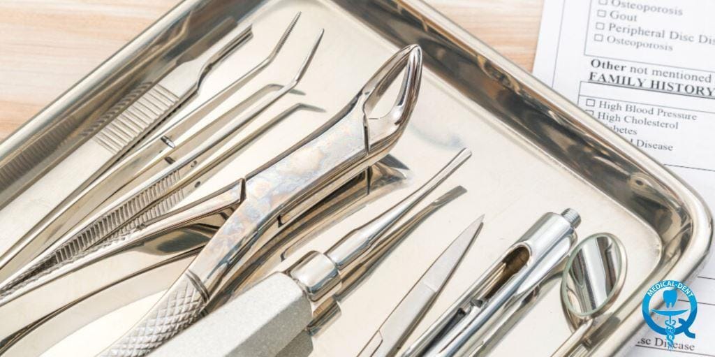 Dental instruments arranged on a metal tray