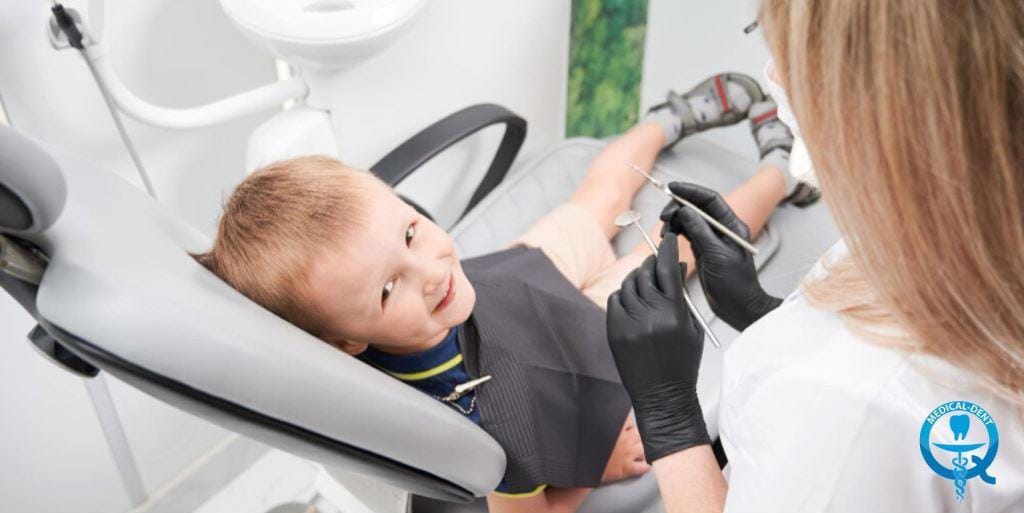 A child seated in a dental chair during a visit