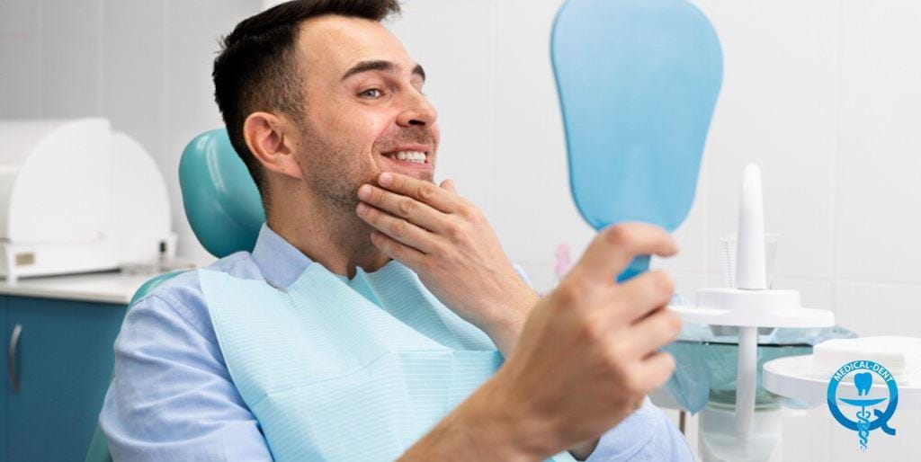 A patient looking at his smile in a handheld mirror