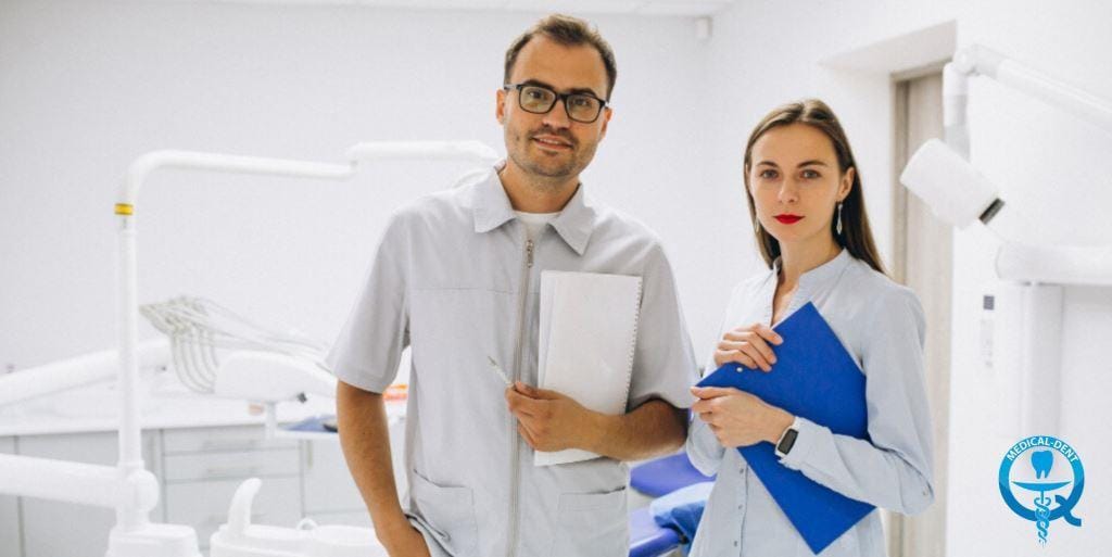 Two members of a dental team holding folders
