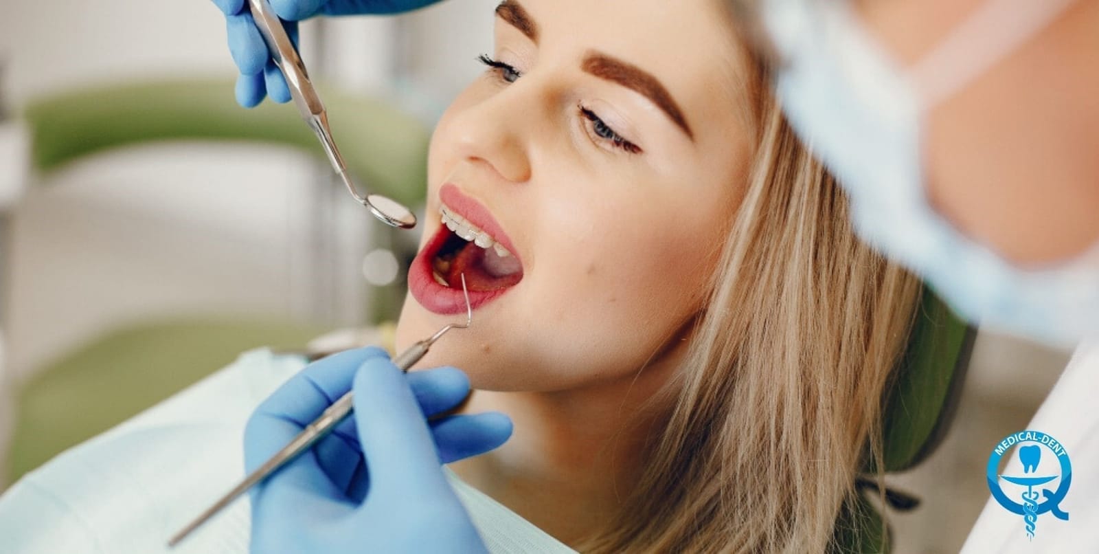 A clinician examining a patient’s teeth with a mirror