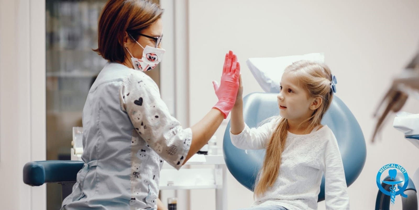 A child and a clinician giving each other a high five