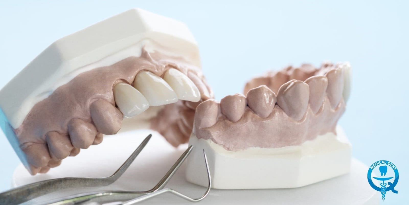 Dental models with restorations beside hand instruments