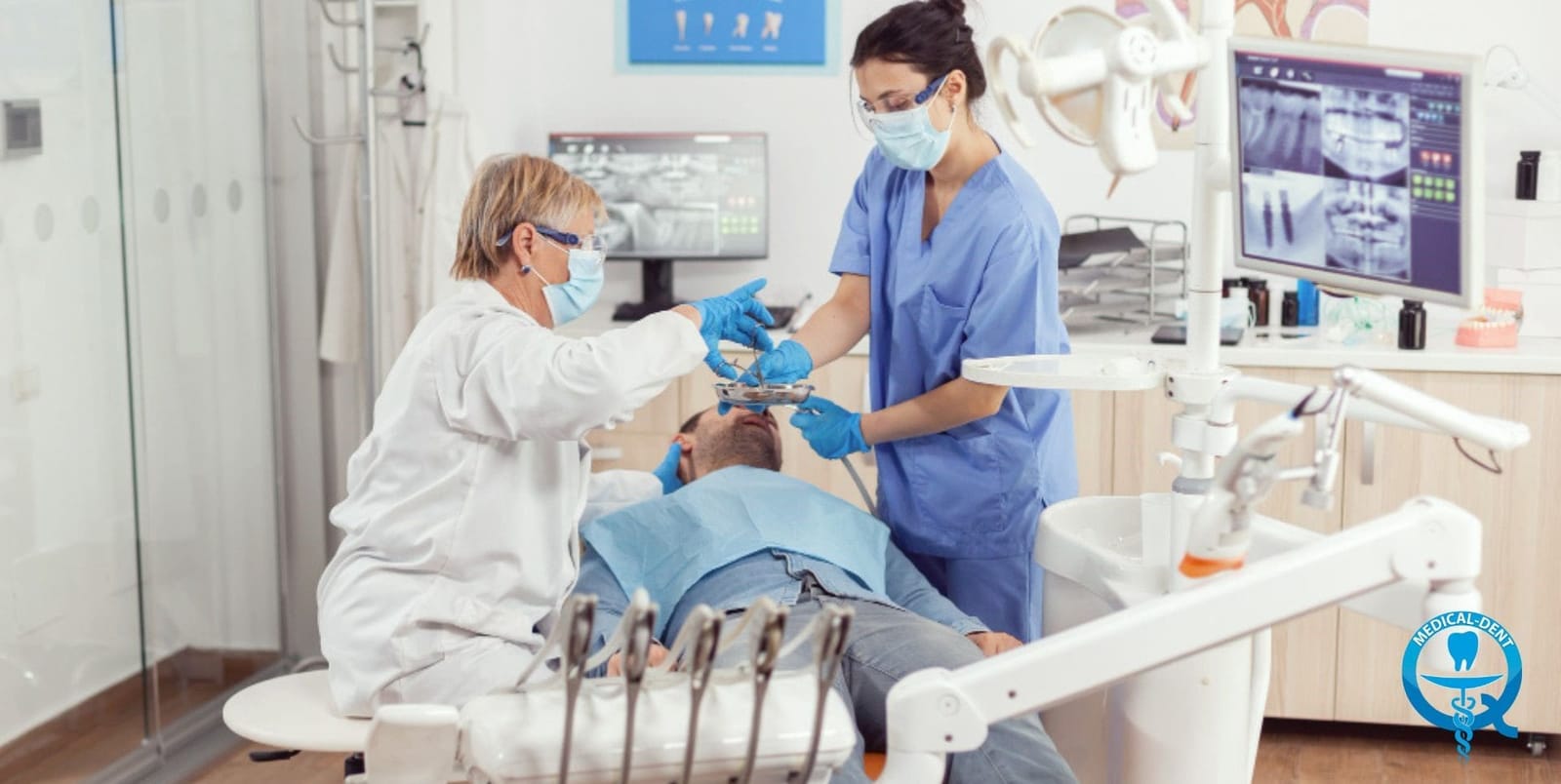 Two dental professionals working beside a patient in a dental chair