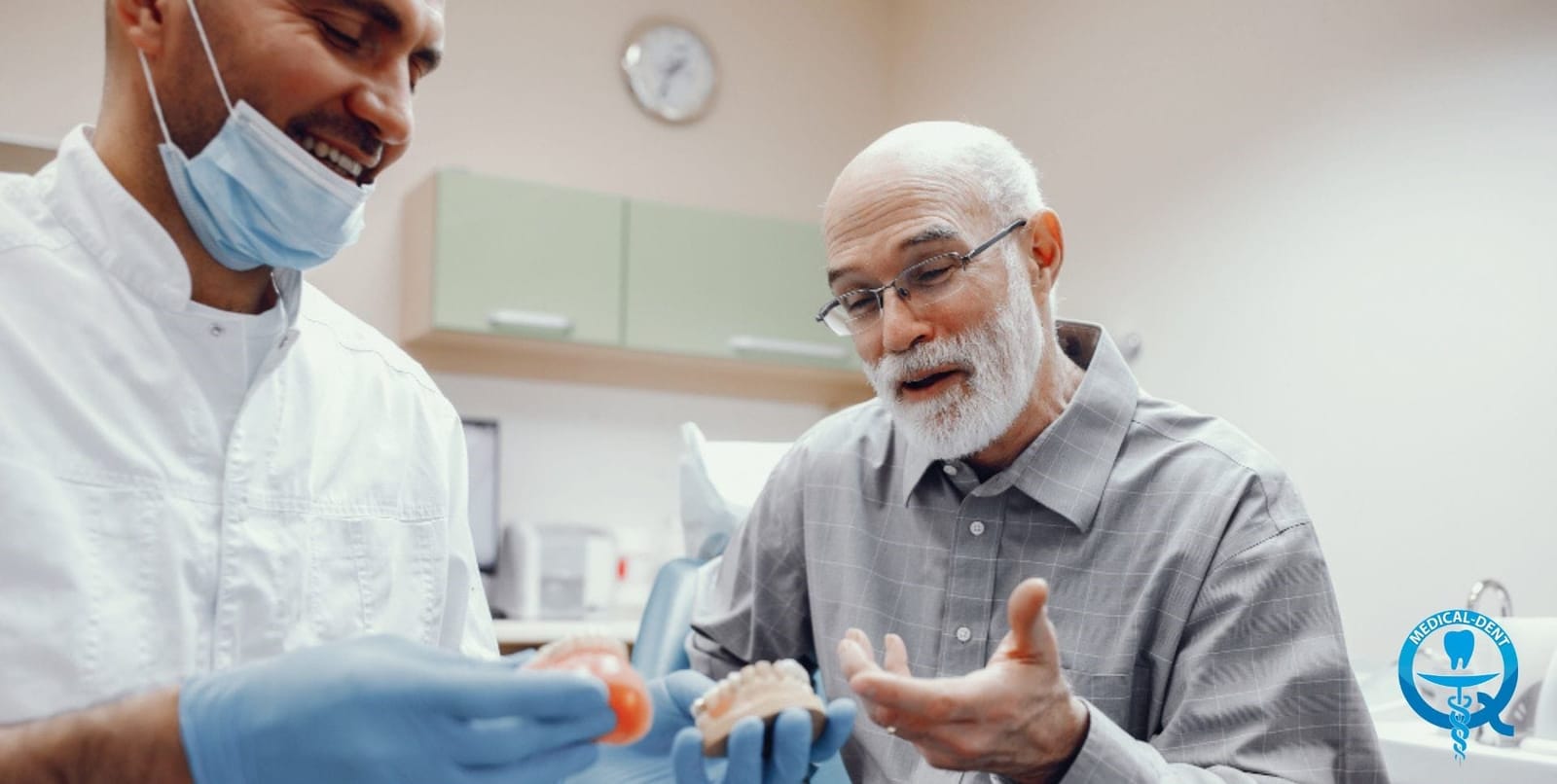 A dentist discussing a dental model with a patient