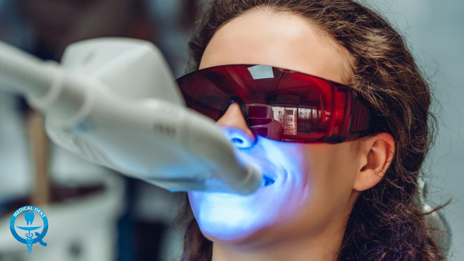 A patient wearing protective glasses during a light-based dental treatment