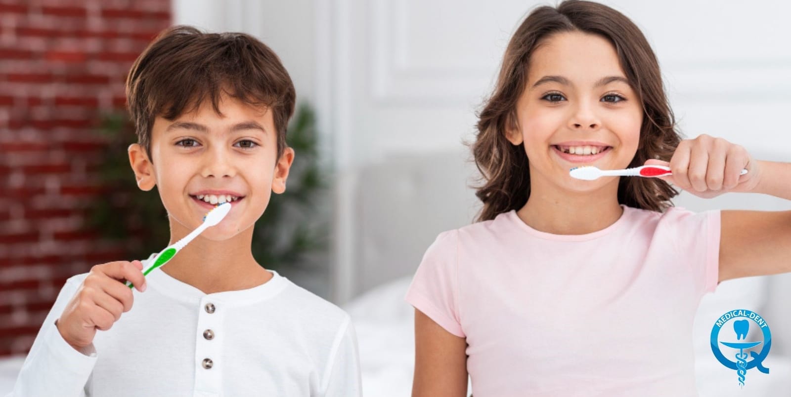 Two children holding toothbrushes and smiling.