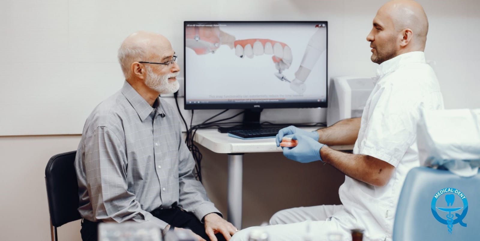 A clinician discussing a dental model on a screen with a patient