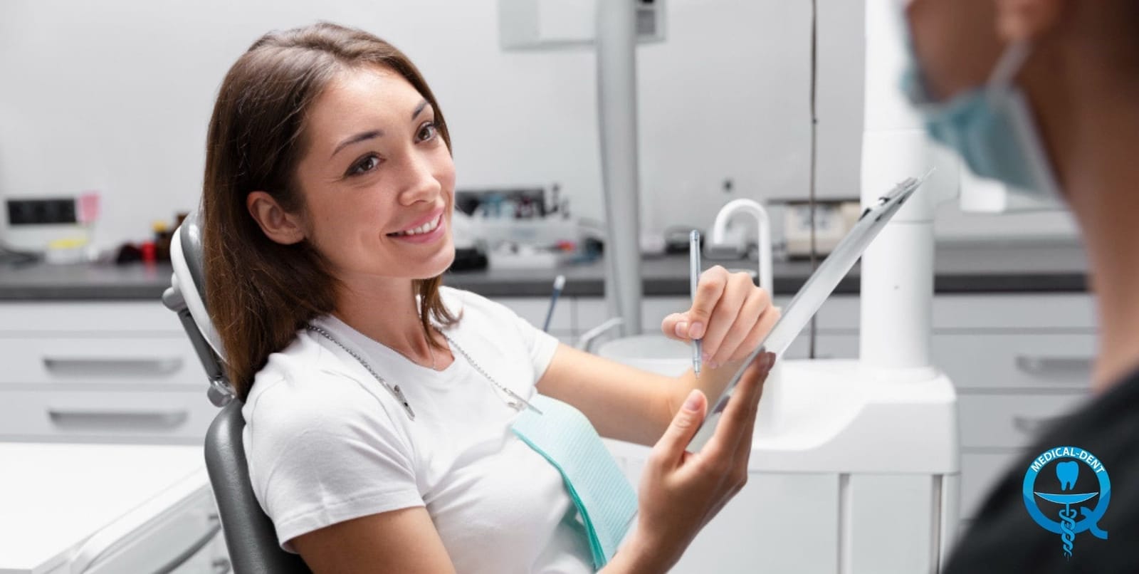 A patient holding a tablet during a dental consultation