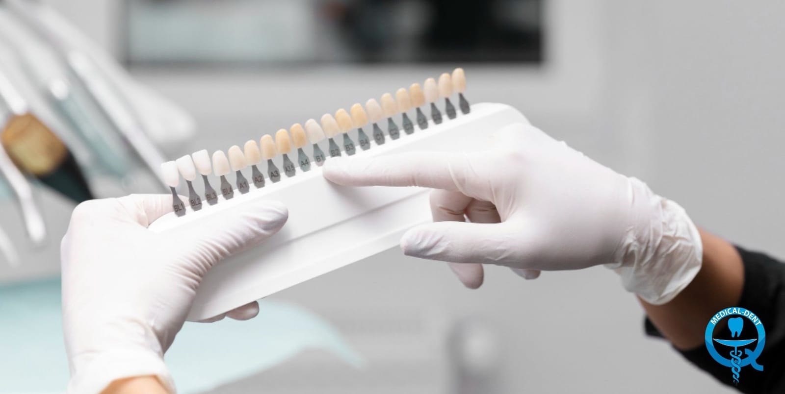 A shade guide being compared with a patient’s teeth