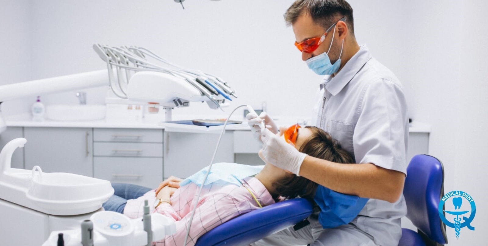 A clinician treating a patient in a dental chair