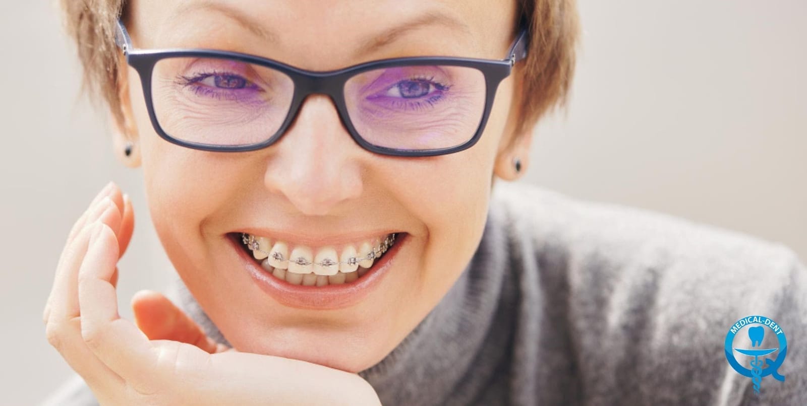 A smiling young person wearing fixed braces