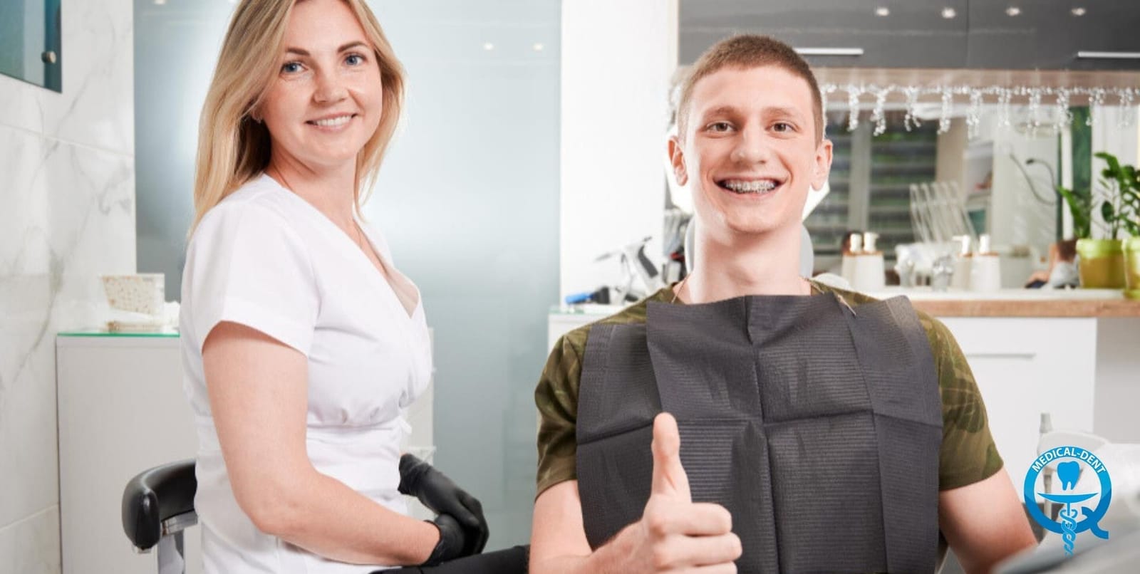 A patient giving a thumbs-up beside a member of the dental team