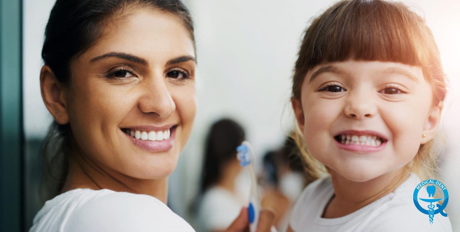Adult and child smiling in a dental surgery