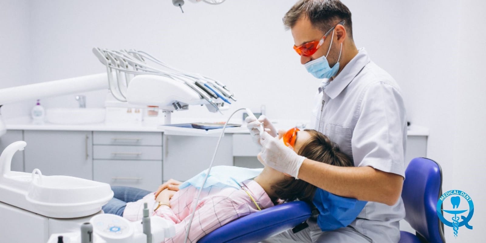 A clinician treating a patient in a dental chair