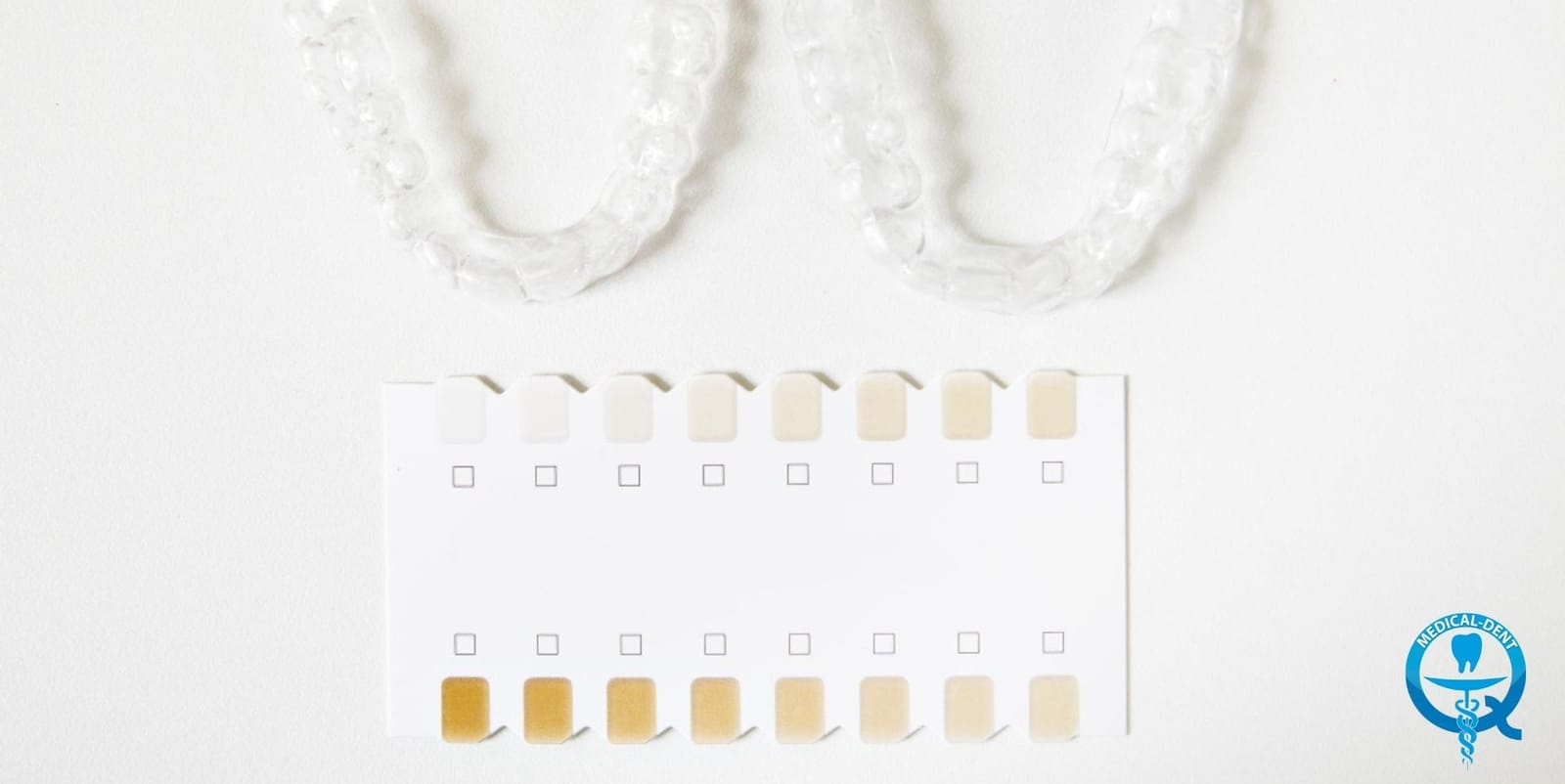 Whitening trays beside a tooth shade chart