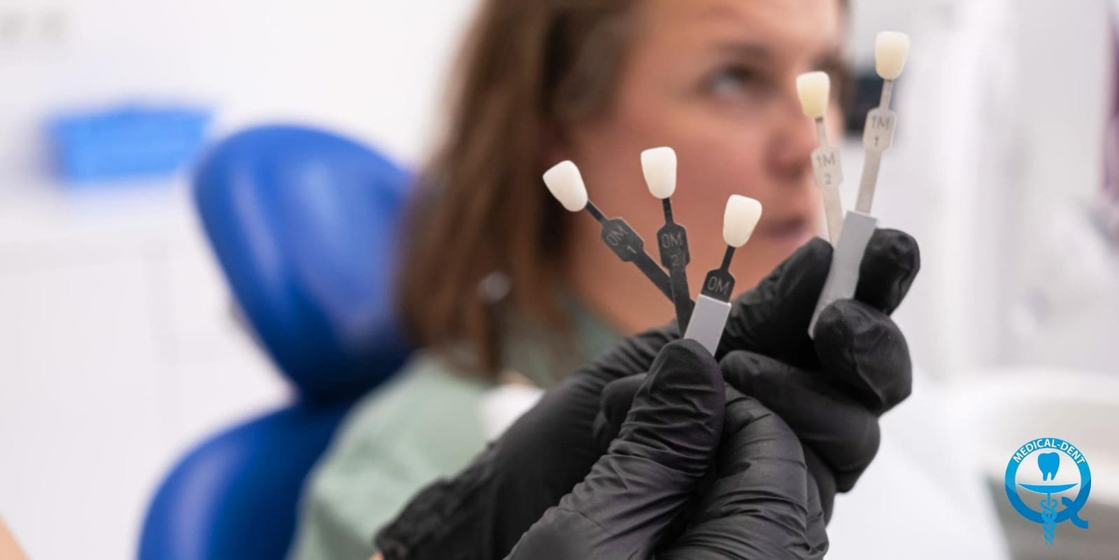 Dental shade samples held beside a patient