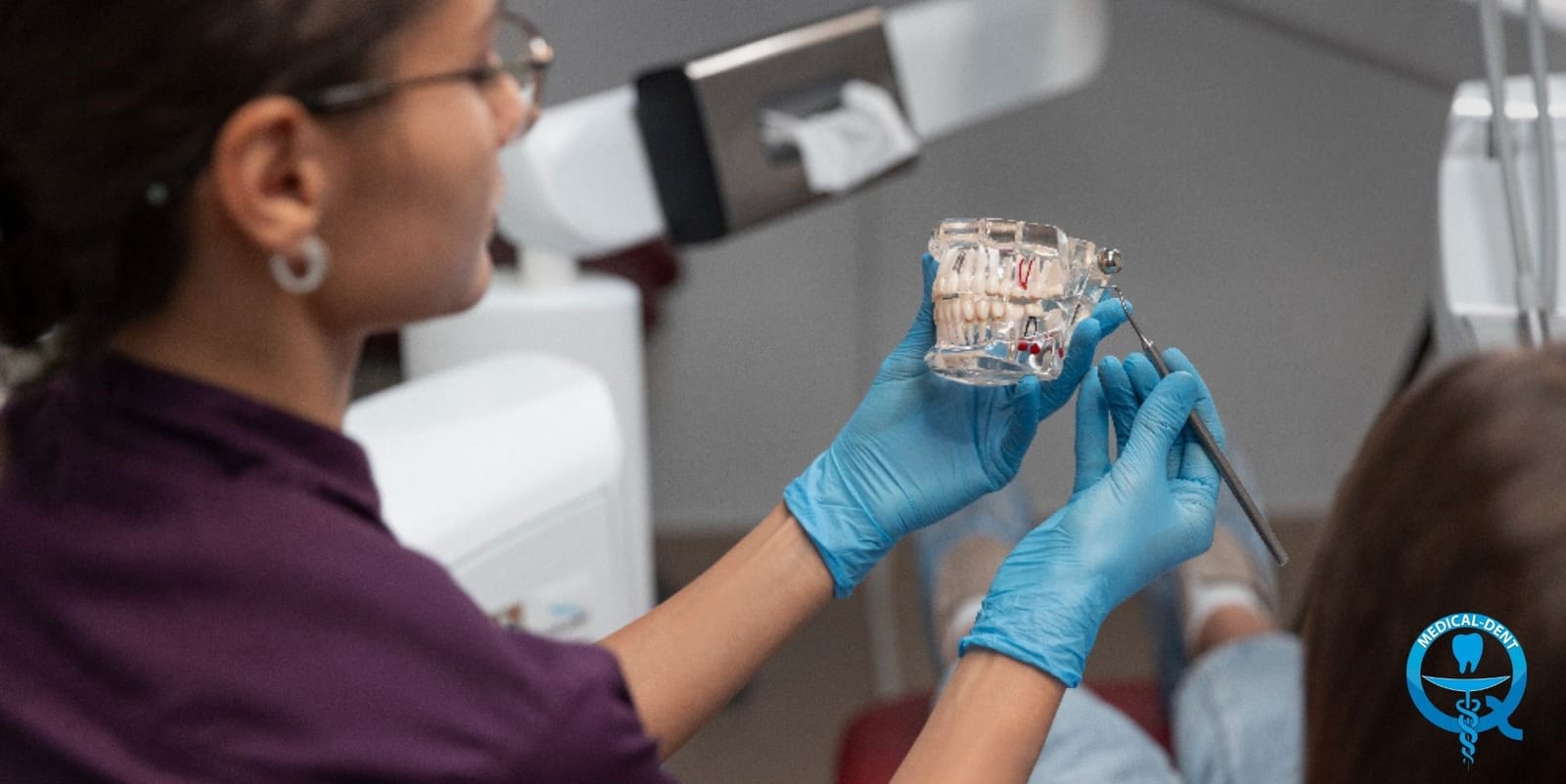 A clinician explaining braces using a dental model