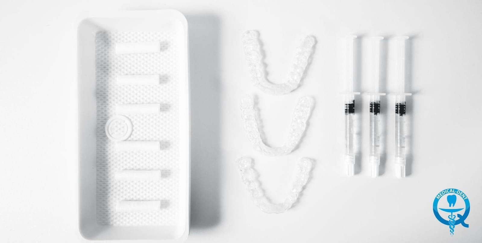 Dental whitening trays and gel syringes in a home kit