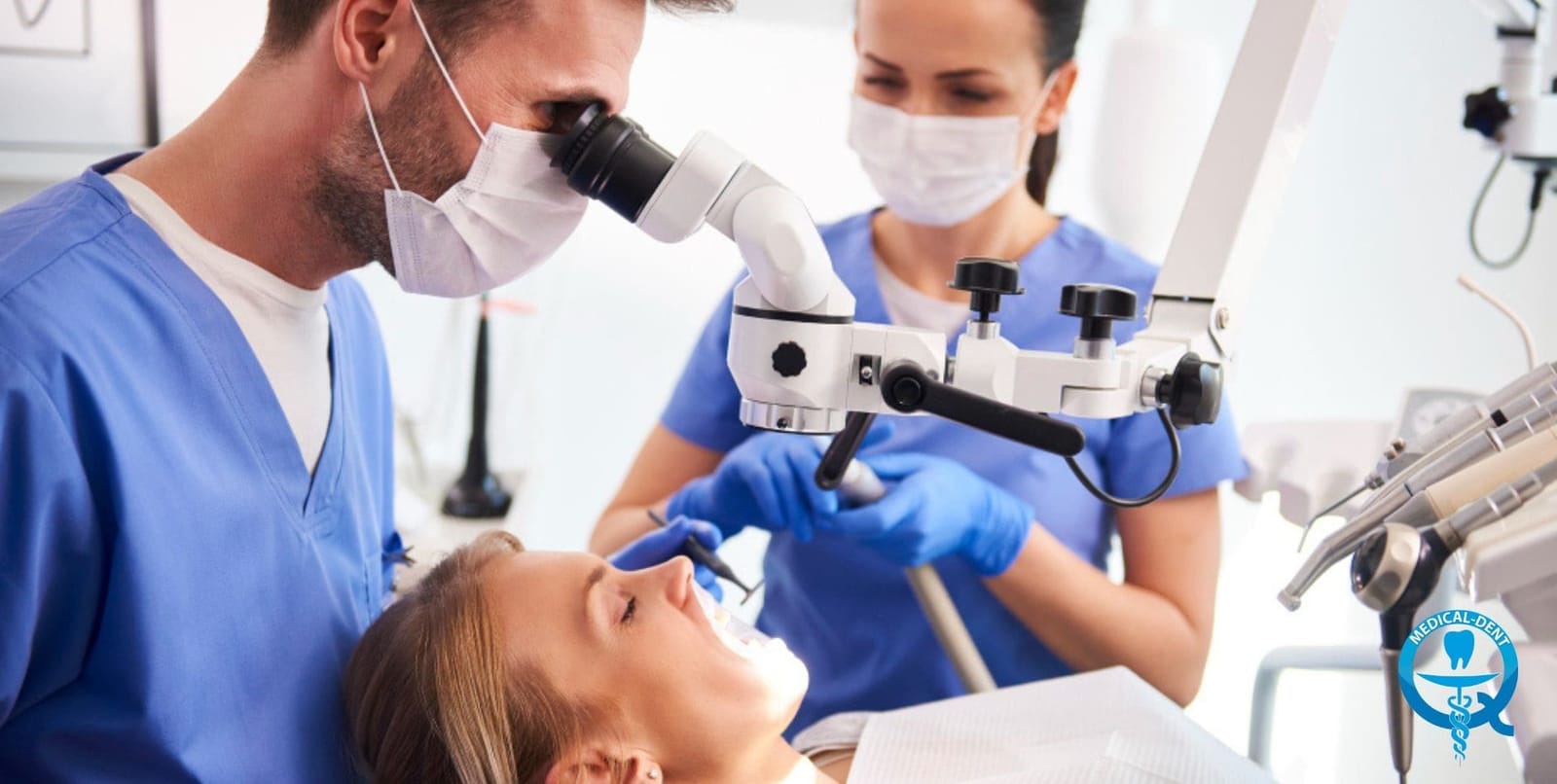 A clinician using a dental microscope while treating a patient