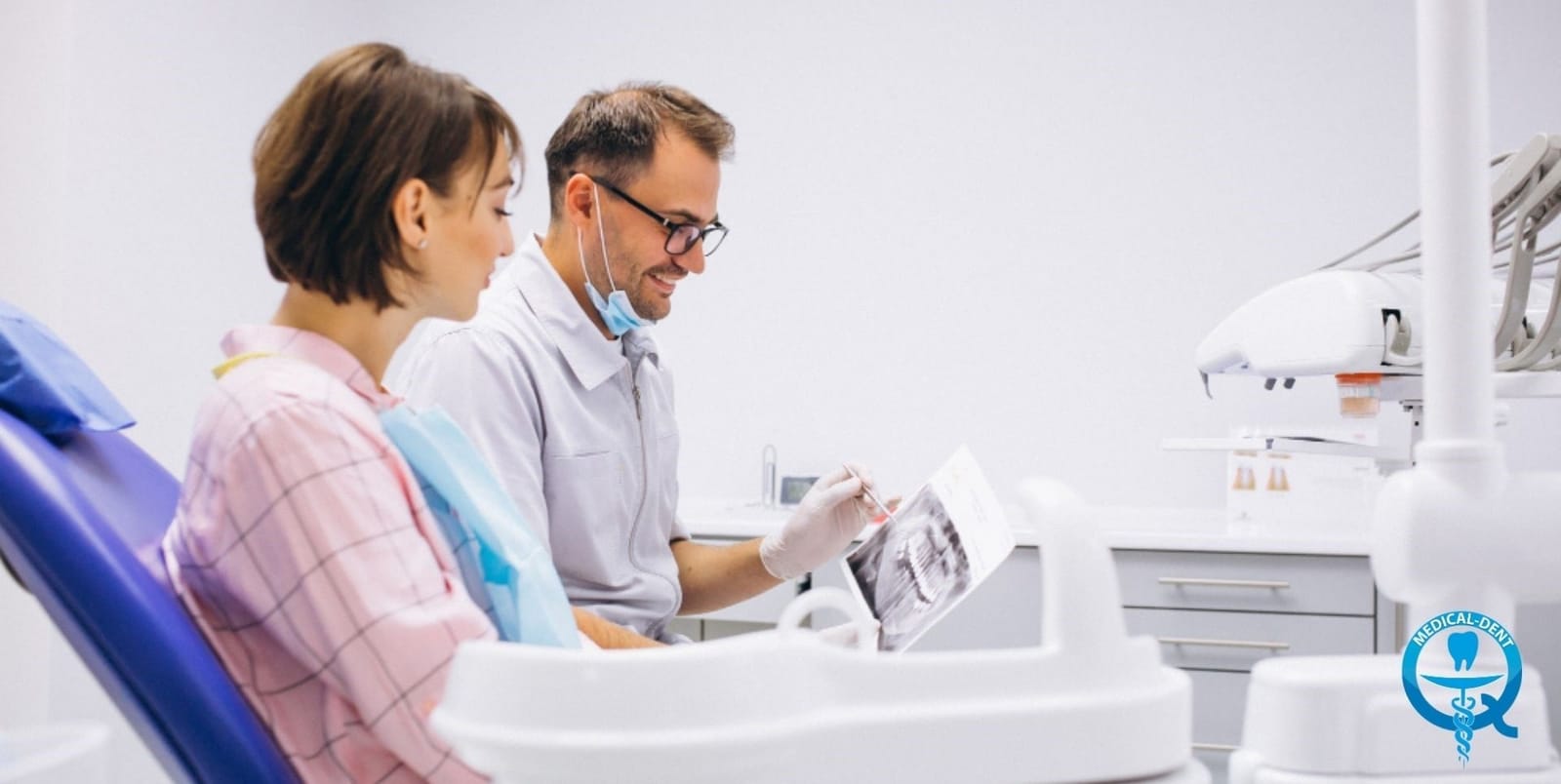 A clinician and patient looking at a dental X-ray