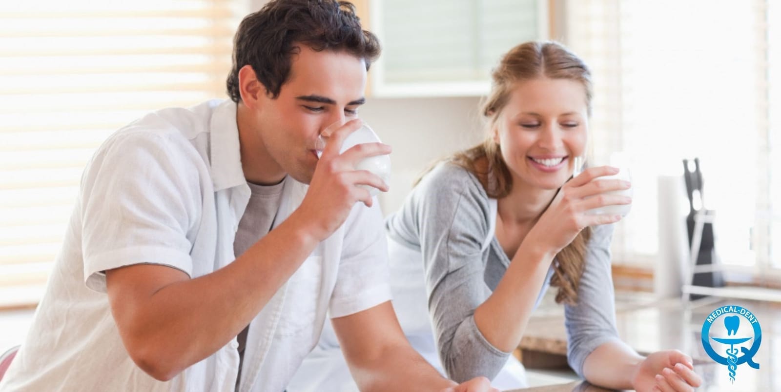 Two people drinking glasses of water