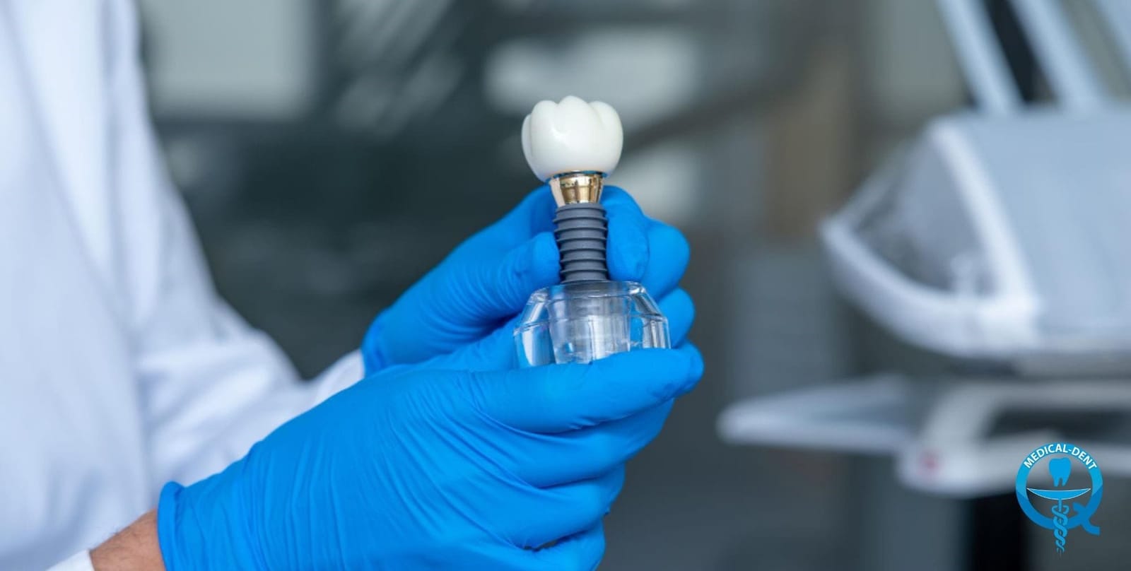 A hand holding a model of an implant-supported tooth