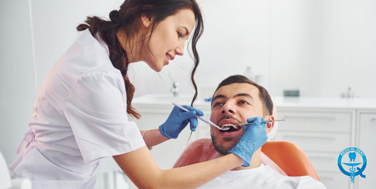 A dentist examining a patient in a dental chair