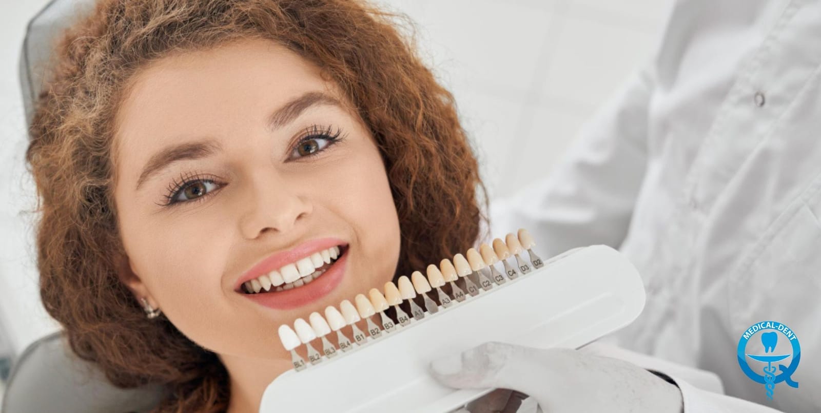 A tooth shade guide held beside a patient’s smile