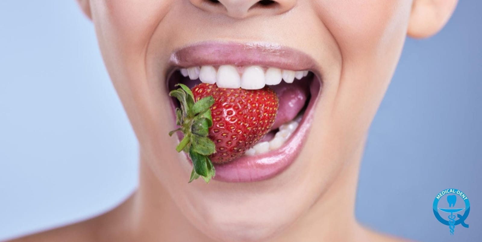 A person biting into a strawberry