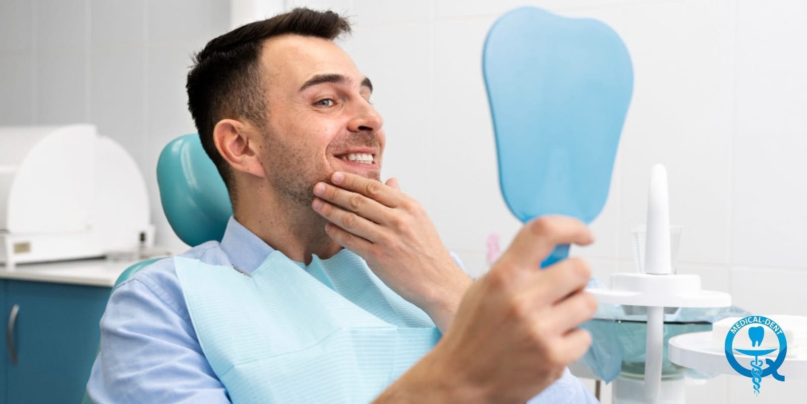 A patient looking at her teeth in a hand mirror in a dental chair
