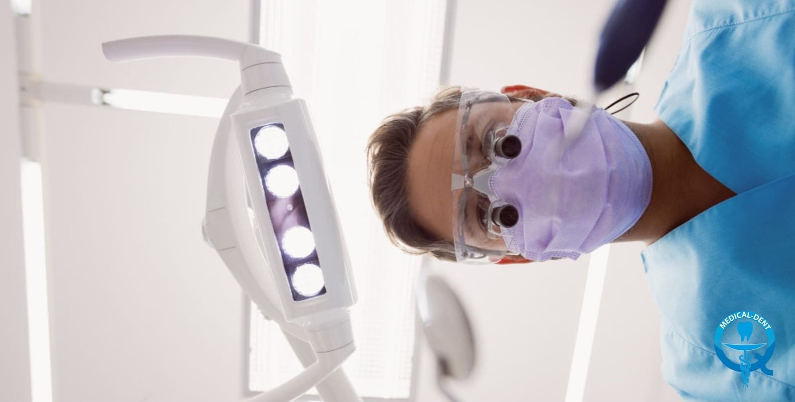 A dental professional wearing a mask and magnifying loupes during treatment