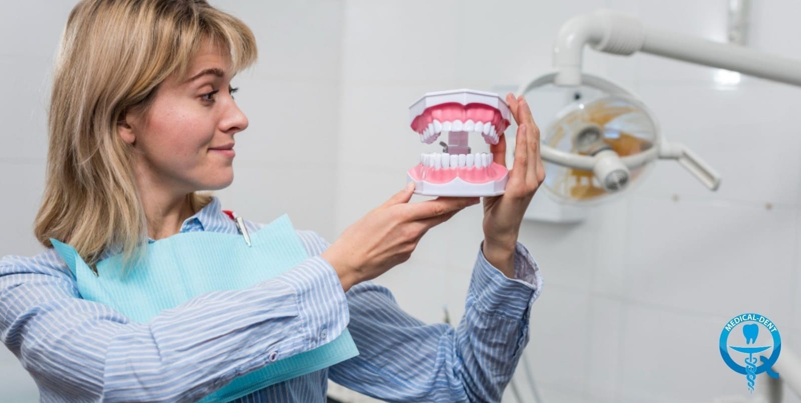 A patient holding a model of teeth