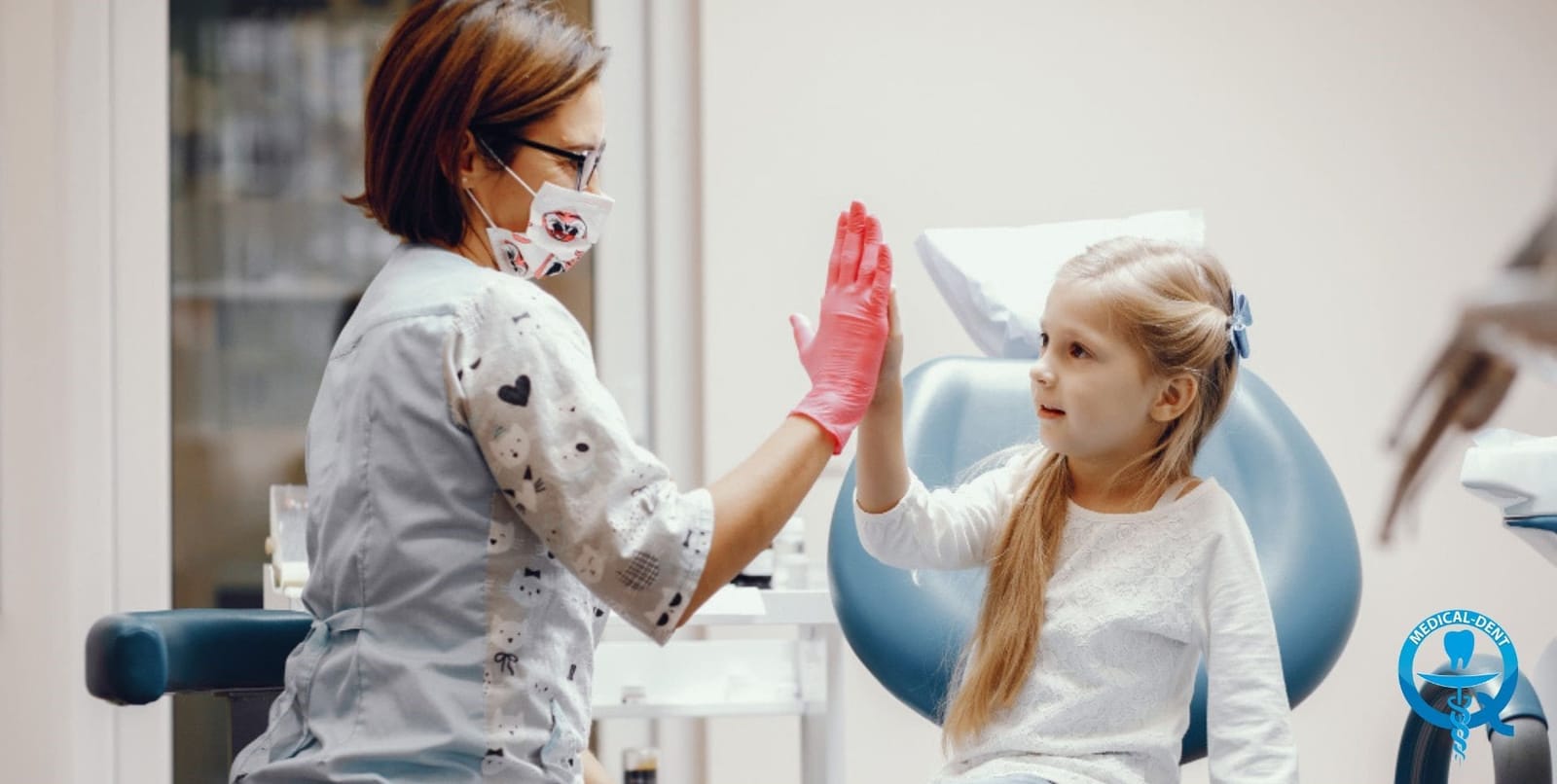 A child giving a dental professional a high five
