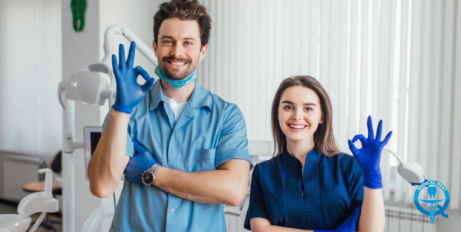 Two members of a dental team wearing blue gloves
