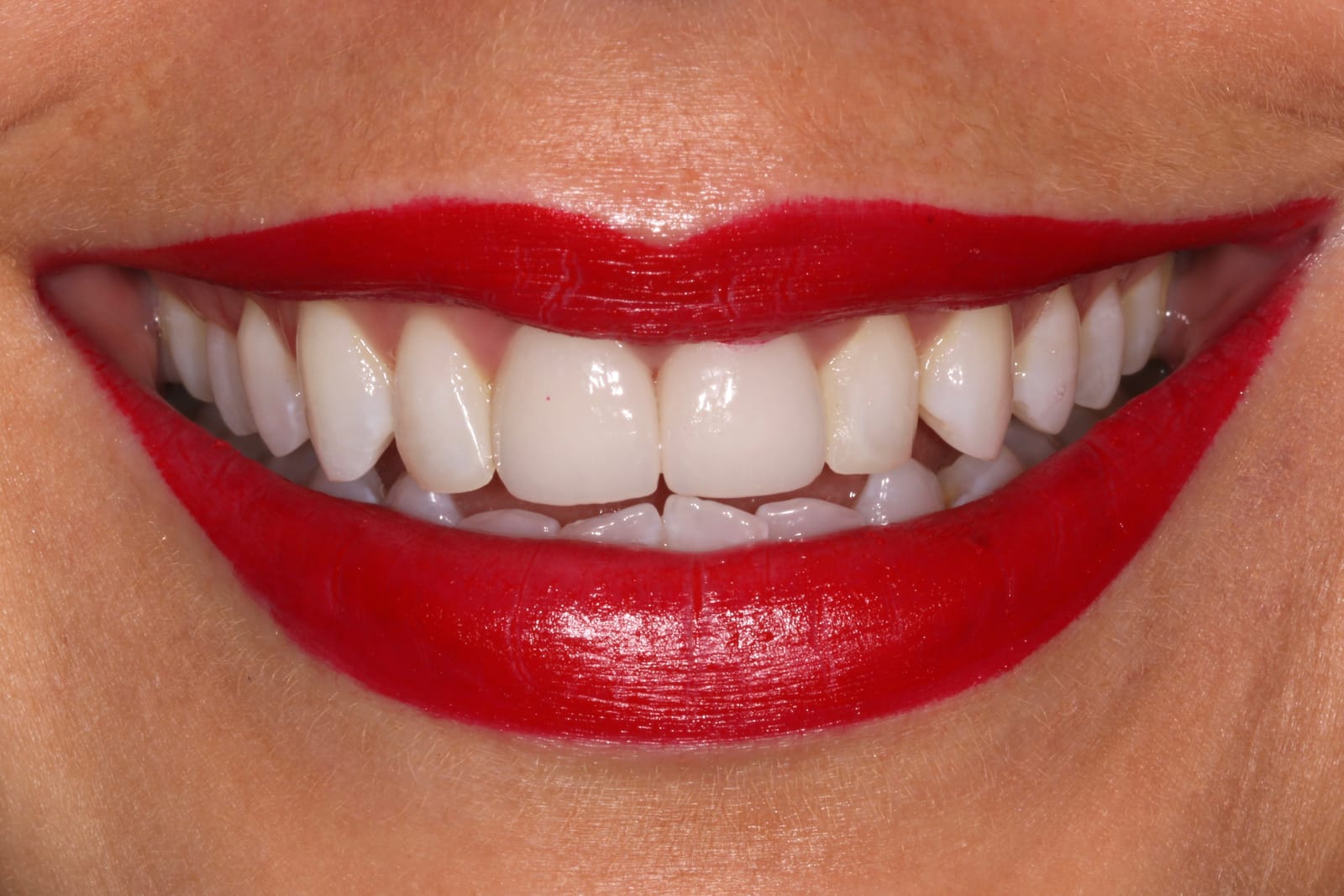 Close-up of a smile with red lipstick
