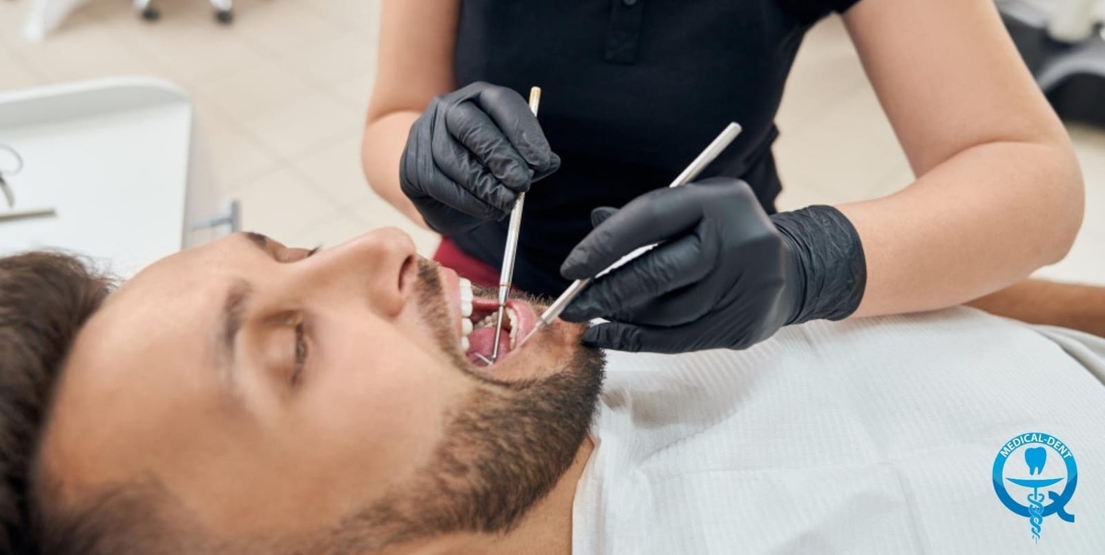A clinician using dental instruments during a patient’s examination or treatment