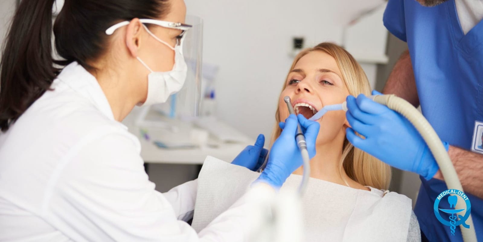 Dentist and assistant treating a patient