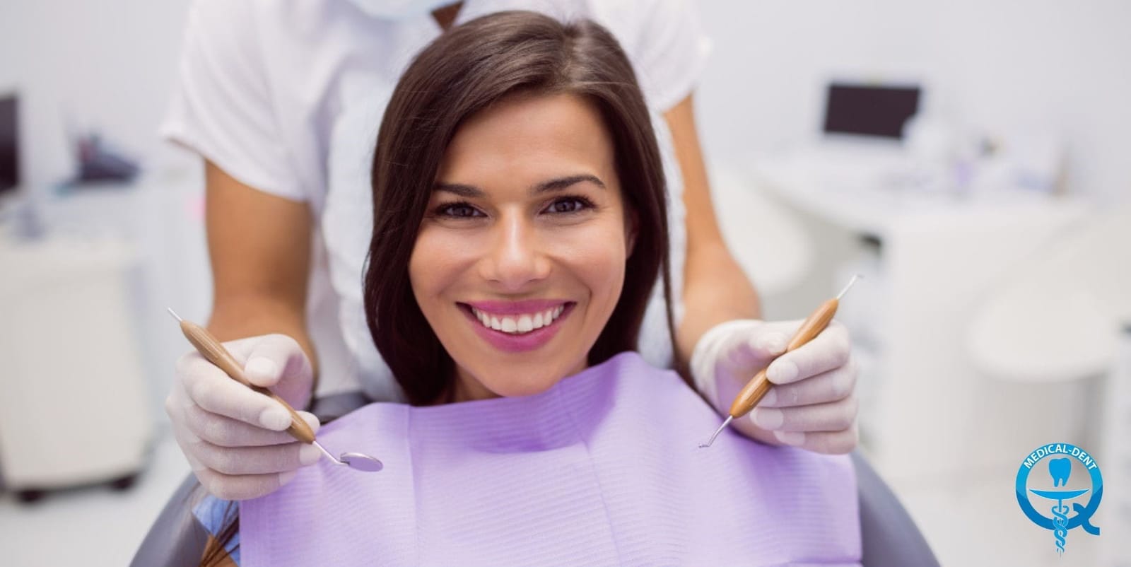 A smiling patient in a dental chair