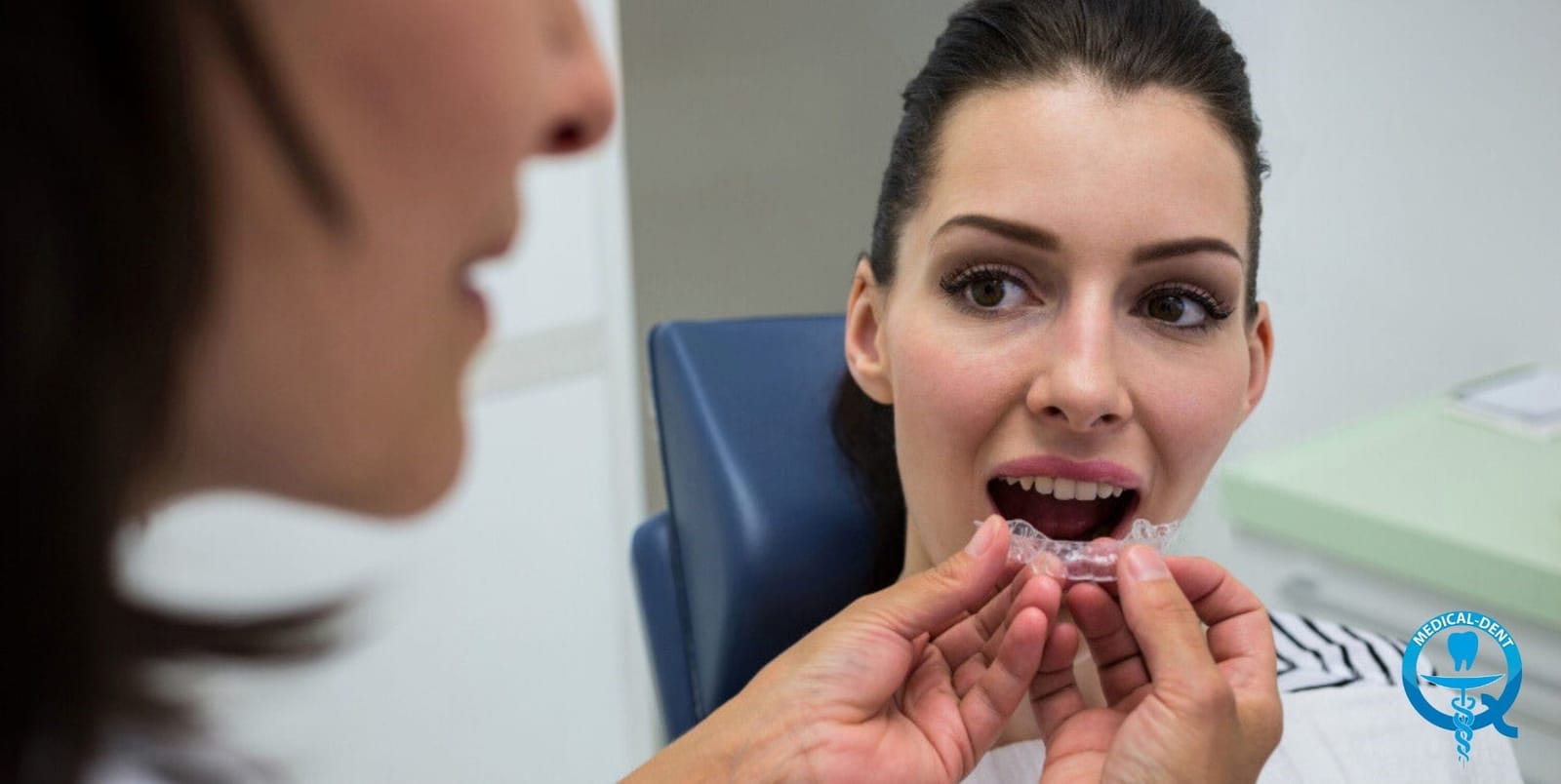Clinician fitting a clear dental tray for a patient