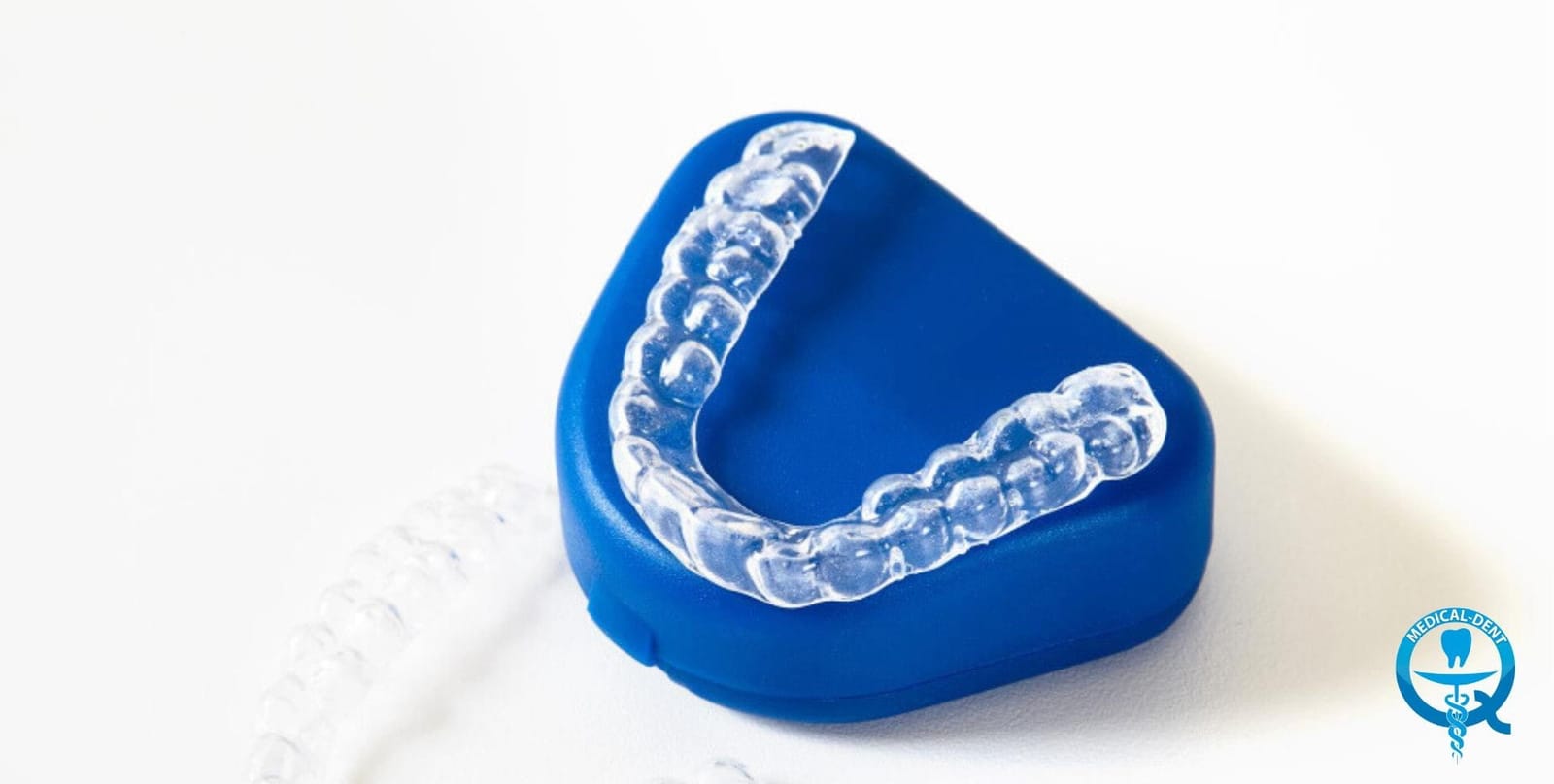 Clear dental tray resting on a blue storage case