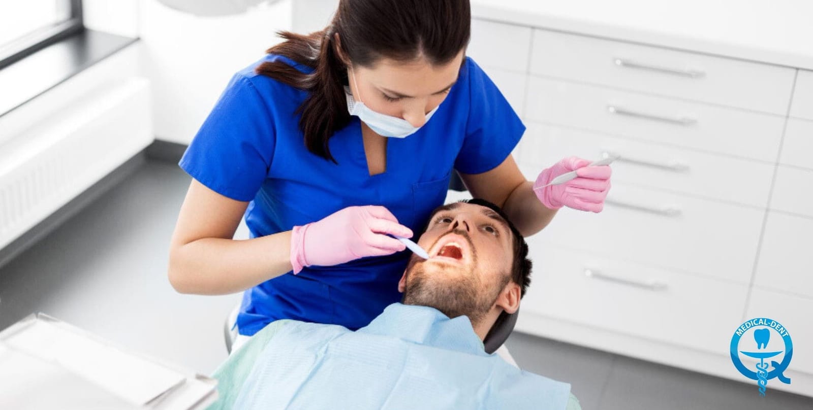 A clinician examining a patient while wearing pink gloves