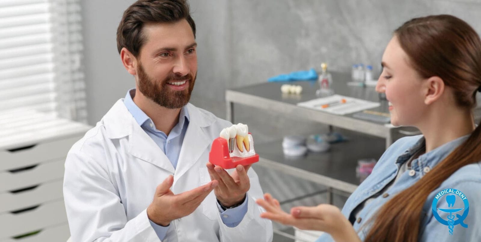 Dentist explaining a tooth model to a patient