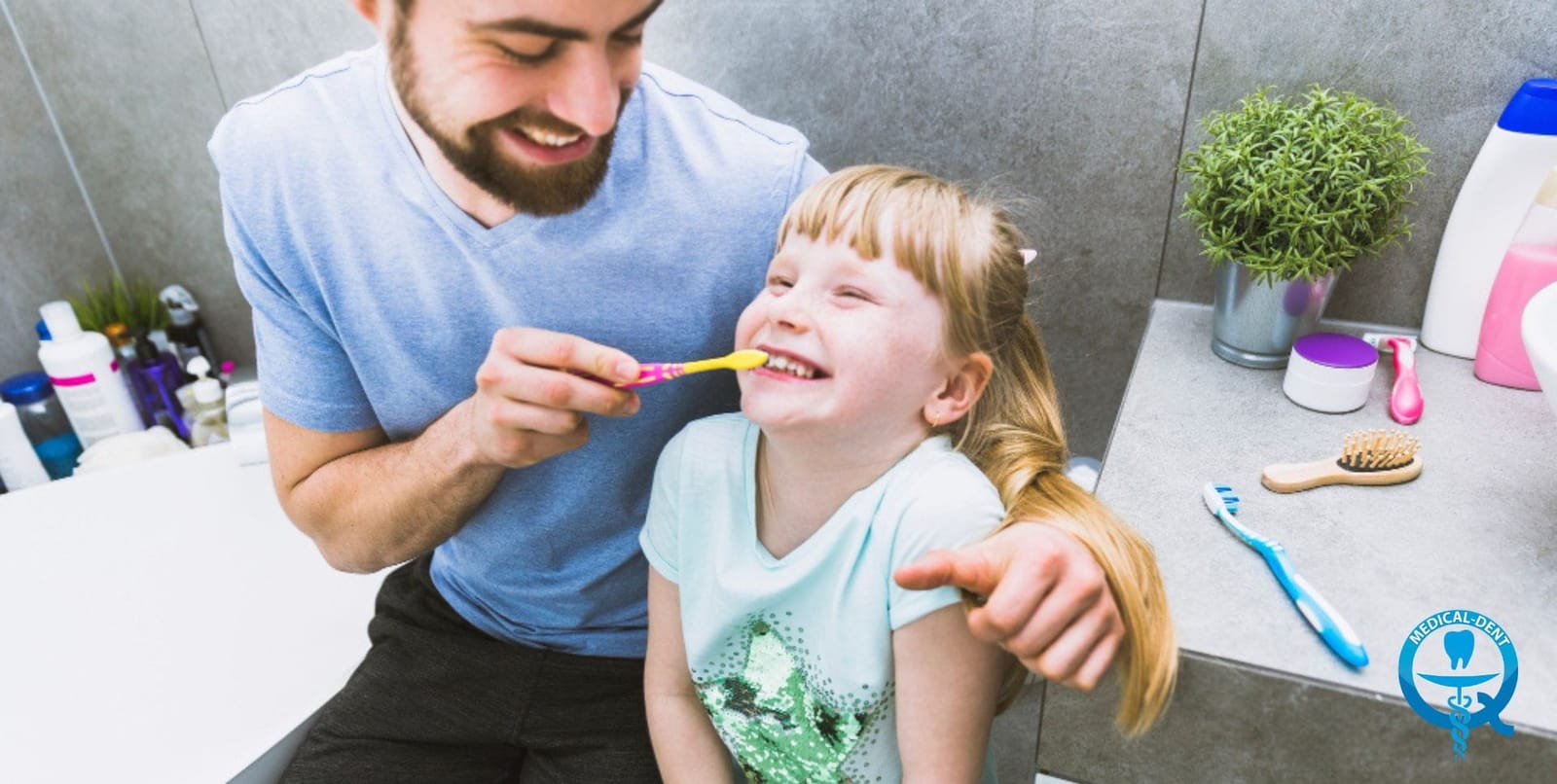 Parent helping a young child brush their teeth