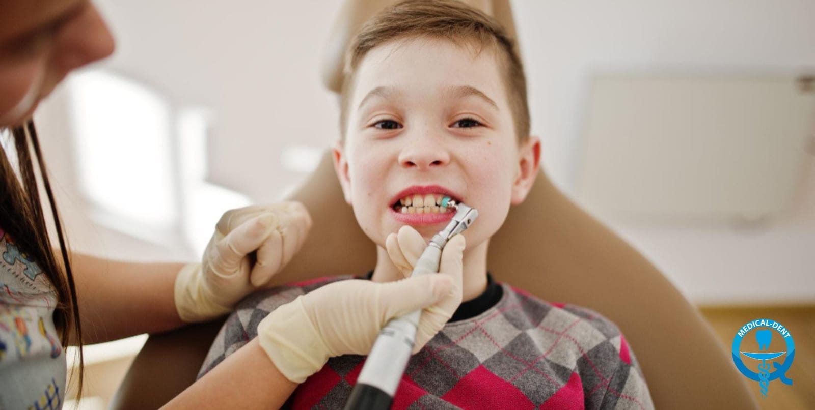 Child having their teeth cleaned in a dental chair
