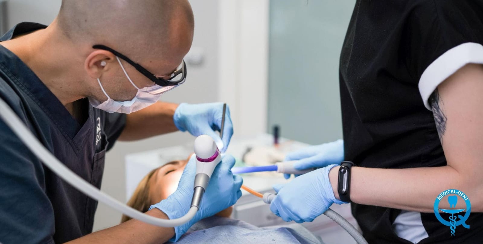 Two clinicians working during a dental procedure