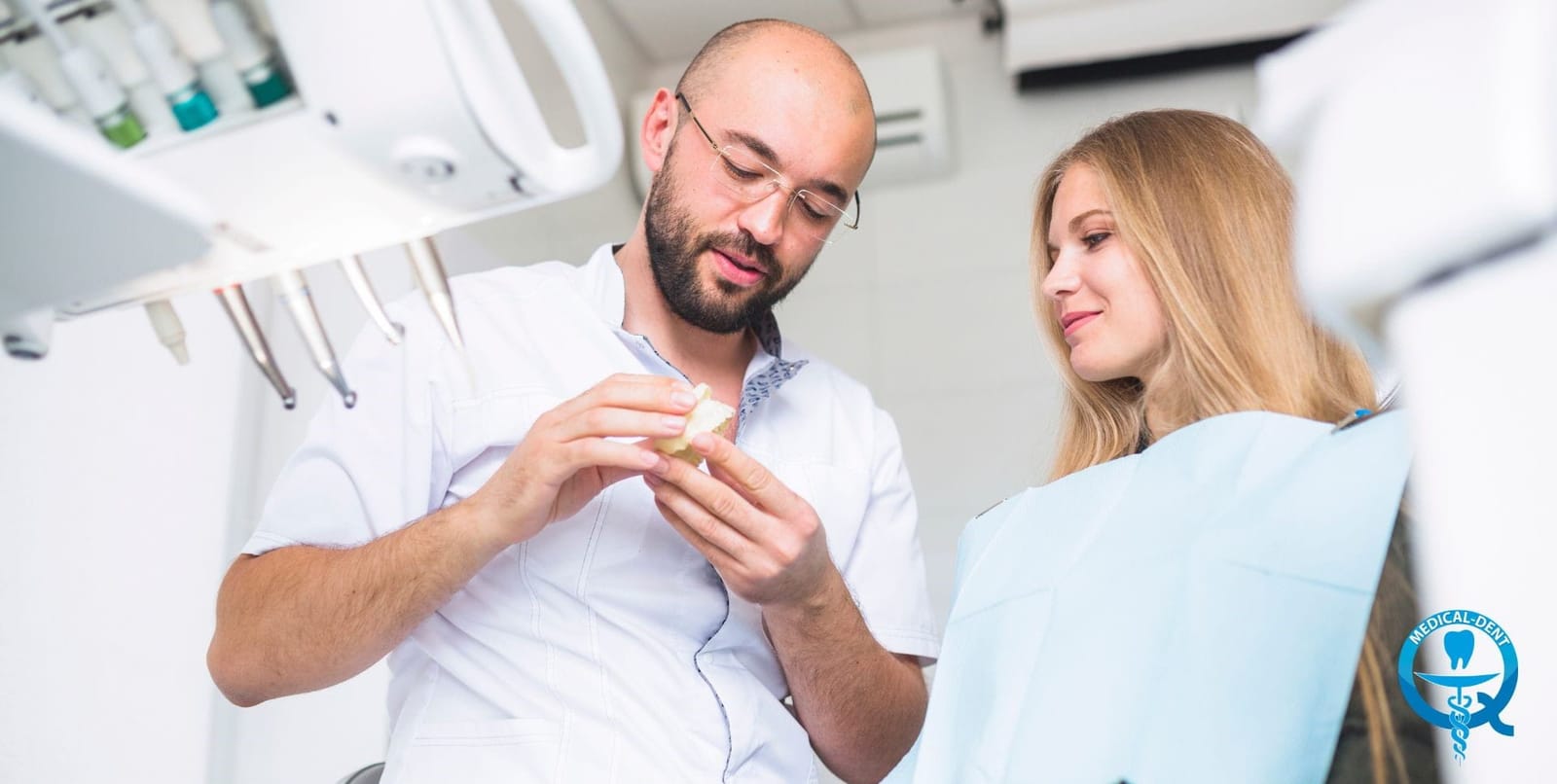 A dental professional explaining a model to a patient