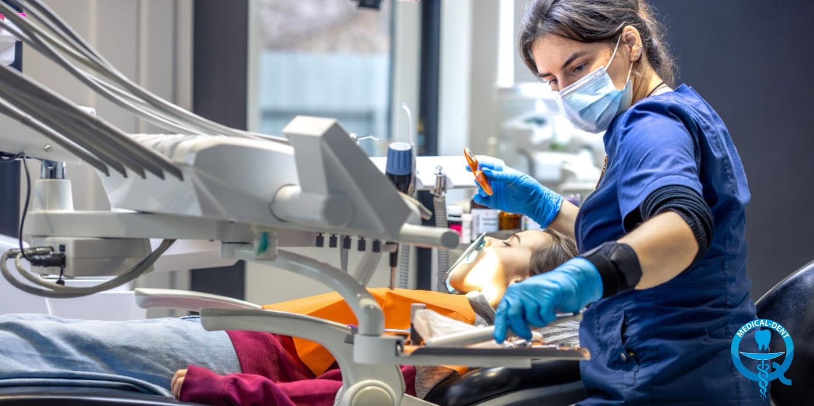 A dental professional treating a patient in a chair
