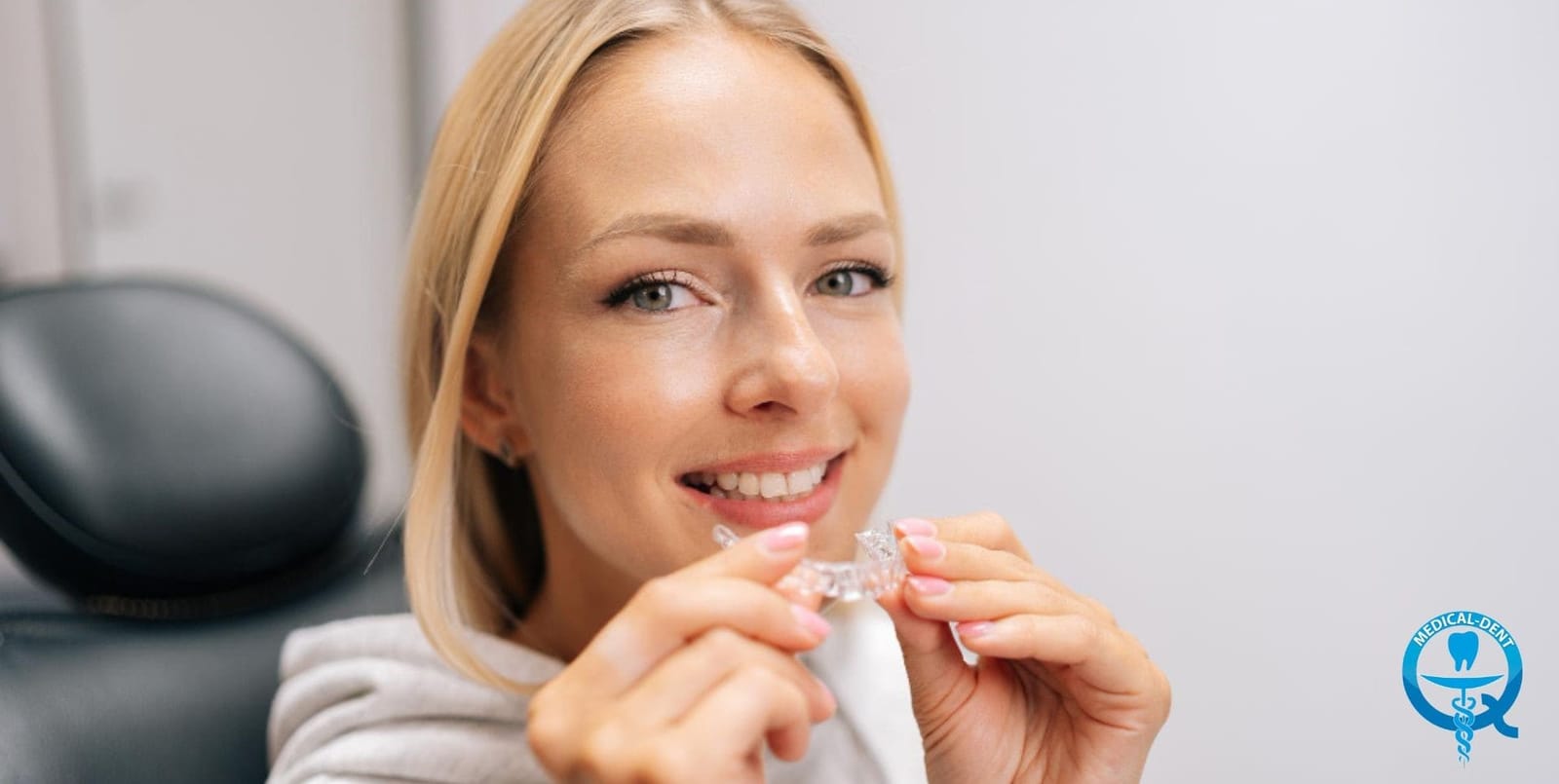 Woman holding a clear dental tray